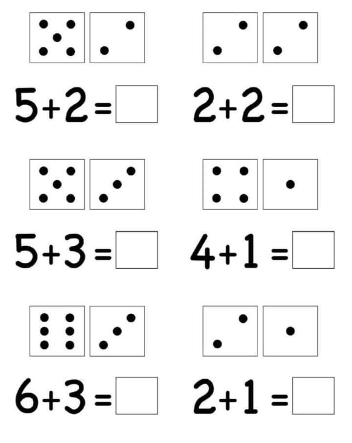 A young child carefully holding a pencil to write numbers on a paper worksheet