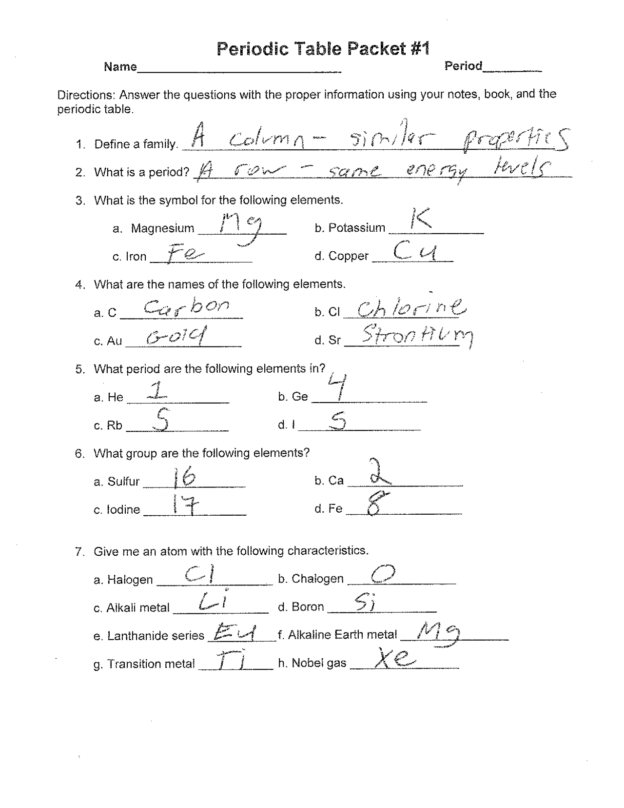 A parent and child discussing a completed chemistry worksheet together at a kitchen table.