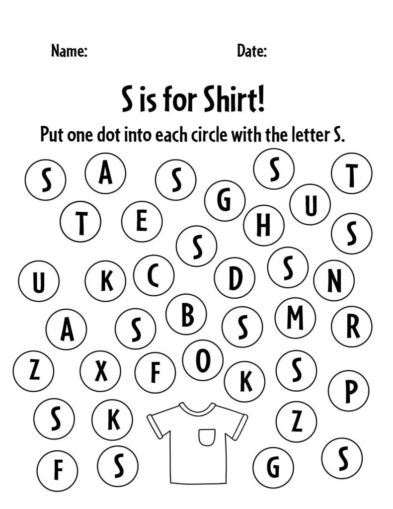 A parent and child sitting together working on printable alphabet activities at a table
