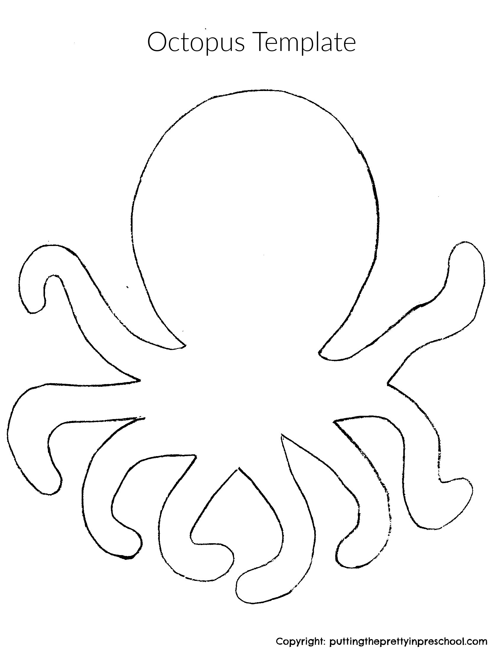 A toddler using crayons to color a simple octopus shape