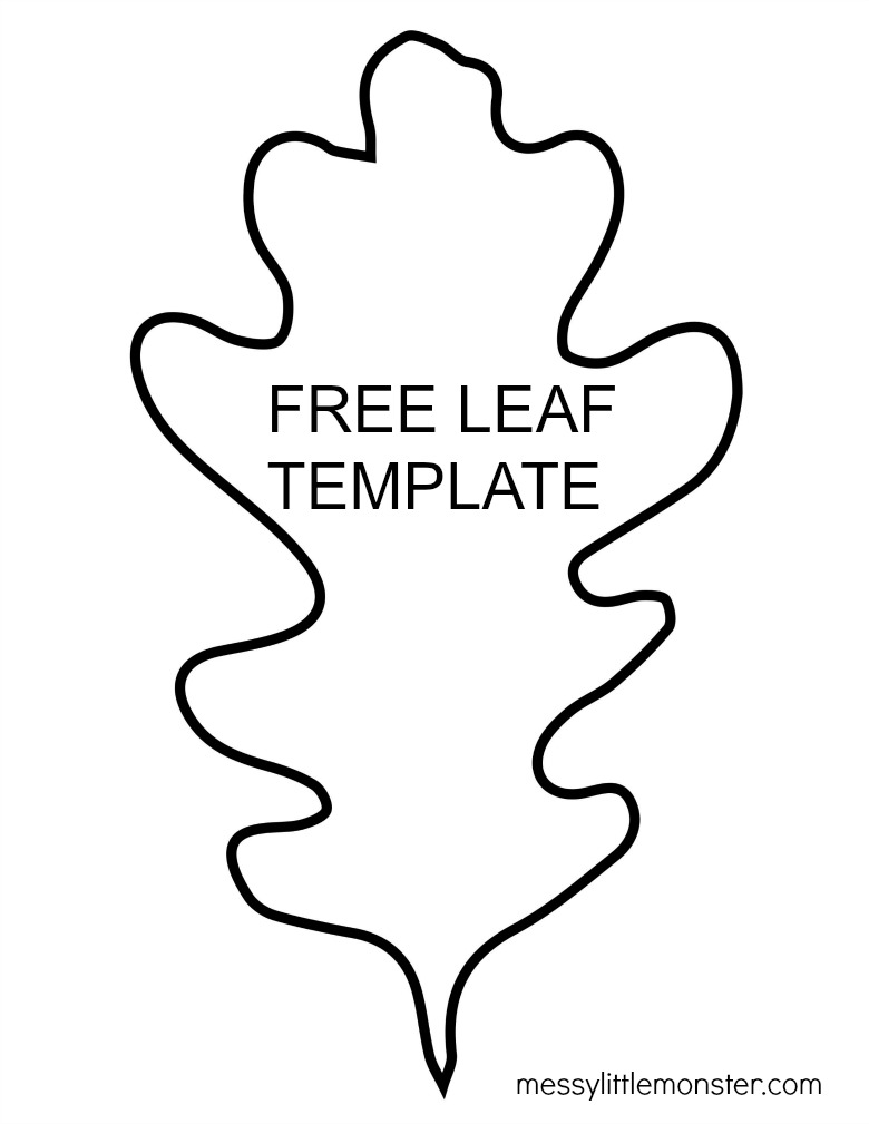 A teacher assisting a young student with cutting out a large paper leaf