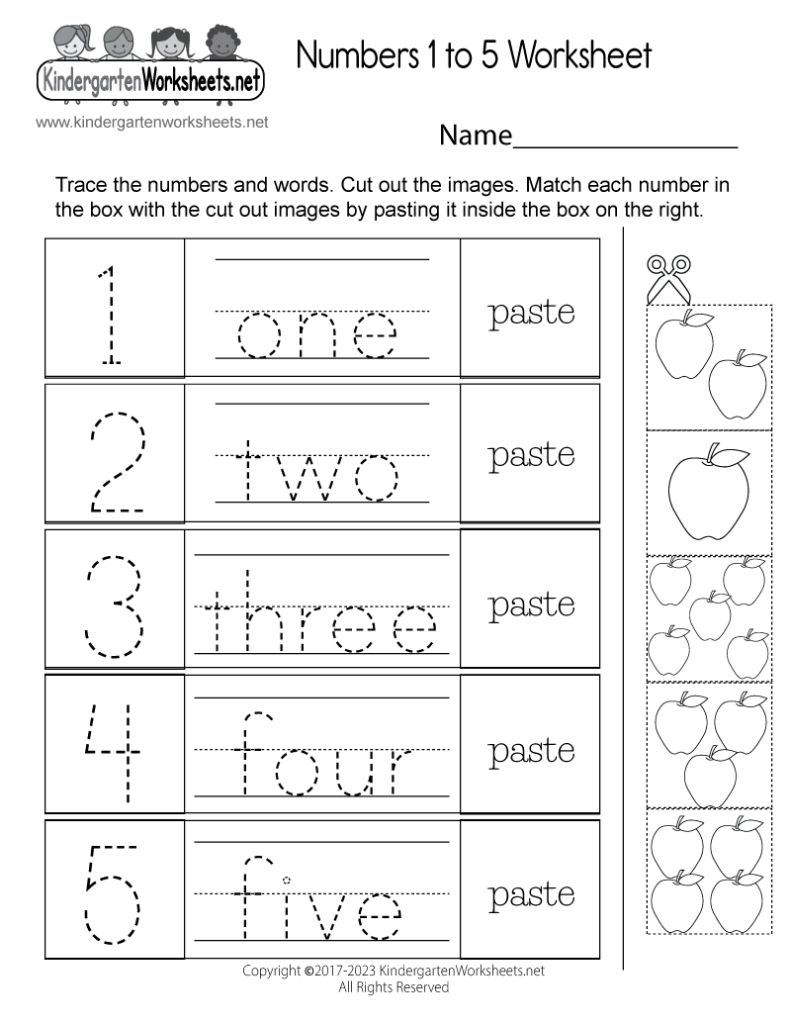 A young child holding a pencil correctly while tracing numbers on a printed sheet