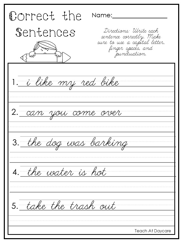 A teacher organizing a stack of laminated cursive practice sheets in a classroom
