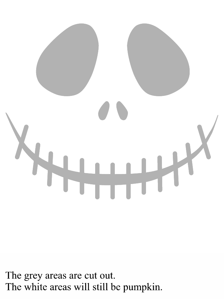 A finished pumpkin next to the original paper template